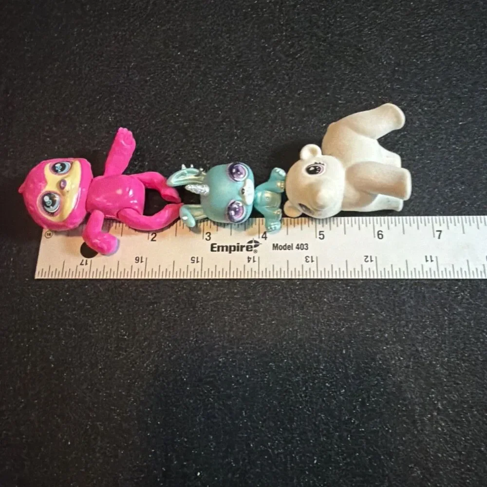 three small collectible toy figurines: Baby Crystals, Bounce Scribble Scrubbie k